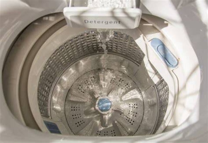 How do you level a top loading washing machine?